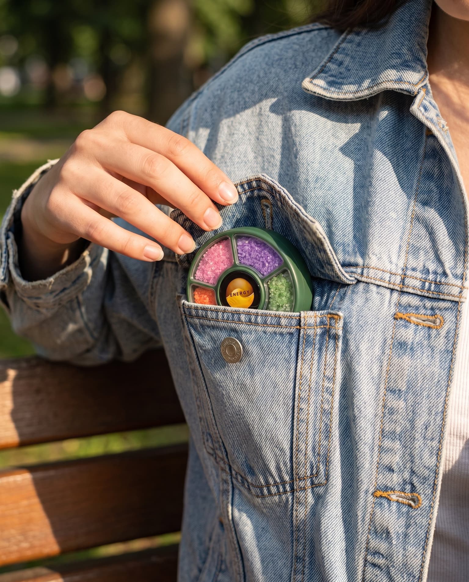 The dial in a denim-jacket chest pocket, flap open: a forest-green shell, five blends showing